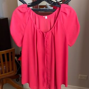 Red blouse with buttons and bow detail